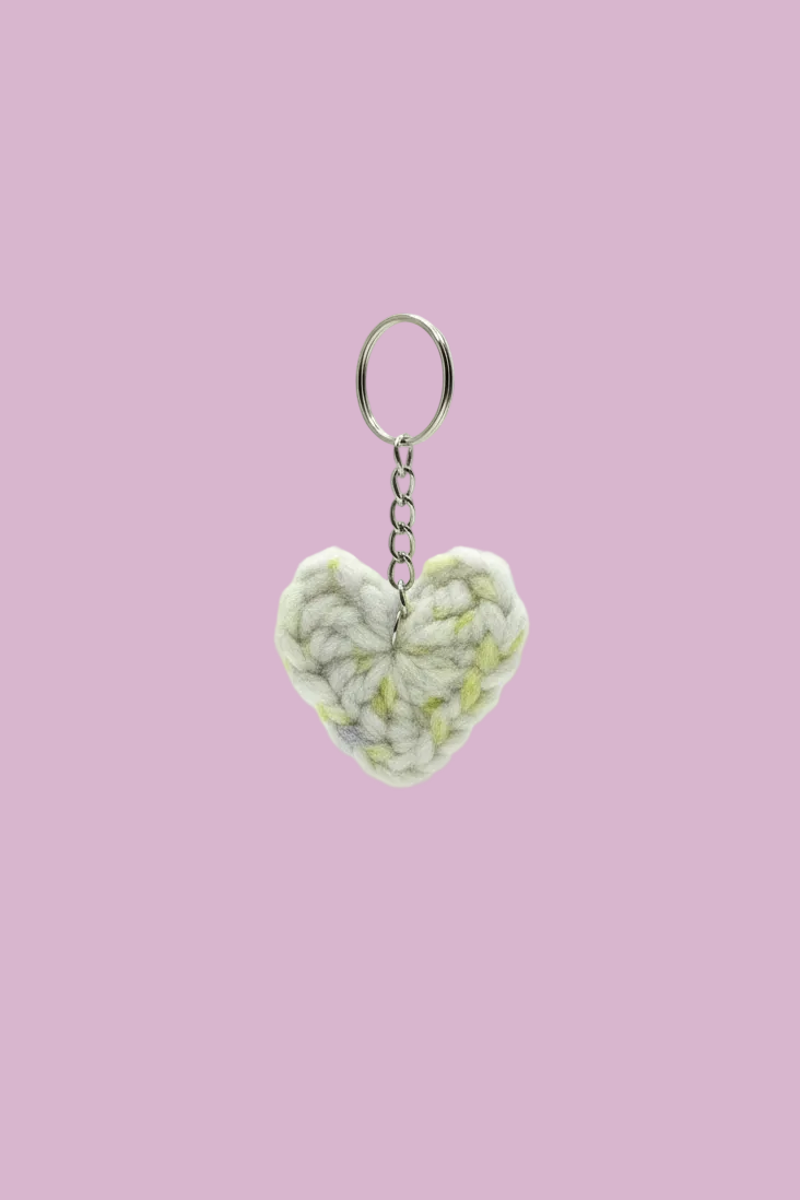 Heart-shaped keychain with a textured pattern on a white background